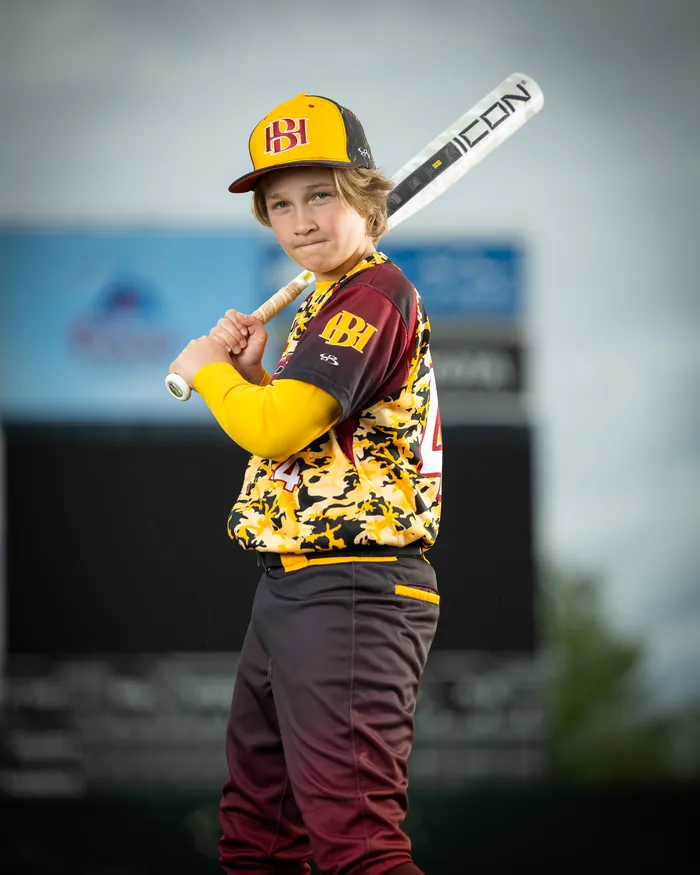 Idaho Hype youth baseball player with bat on shoulder at Memorial Stadium, Boise Idaho