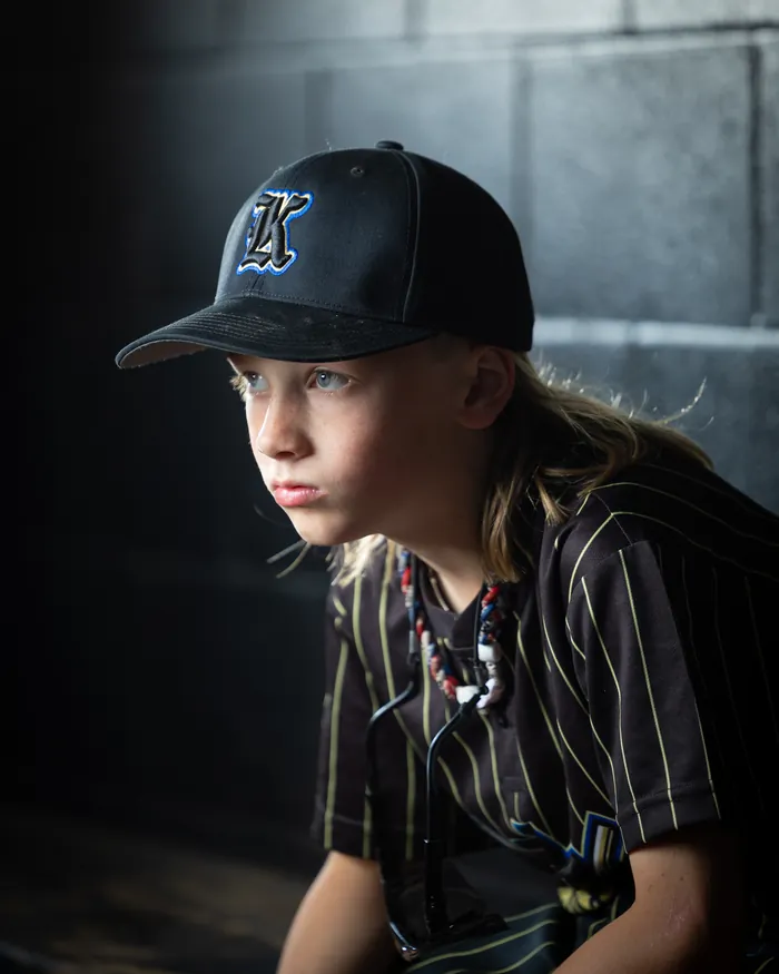 Kuna Outlaws youth baseball player dramatic dugout close-up, Kuna Idaho