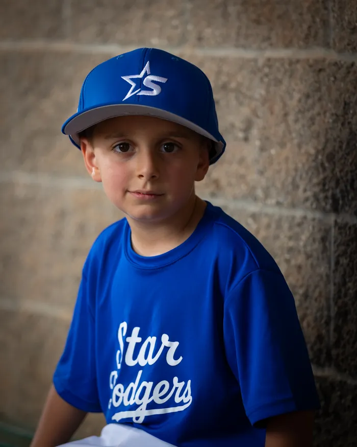 Star Dodgers youth baseball player close-up in the dugout, Star Idaho