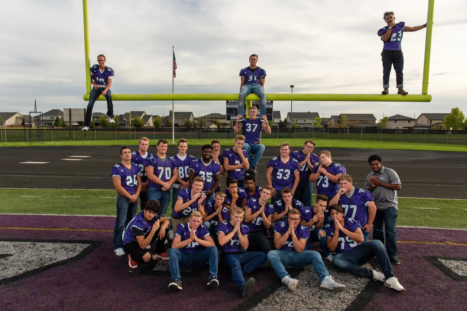 Rocky Mountain High School football seniors posed on the goalposts at their stadium, Meridian Idaho, September 2018