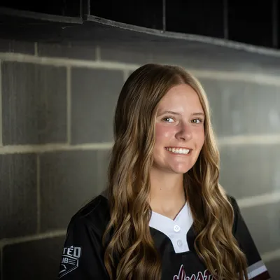 Idaho Batbusters 16U softball player dugout portrait