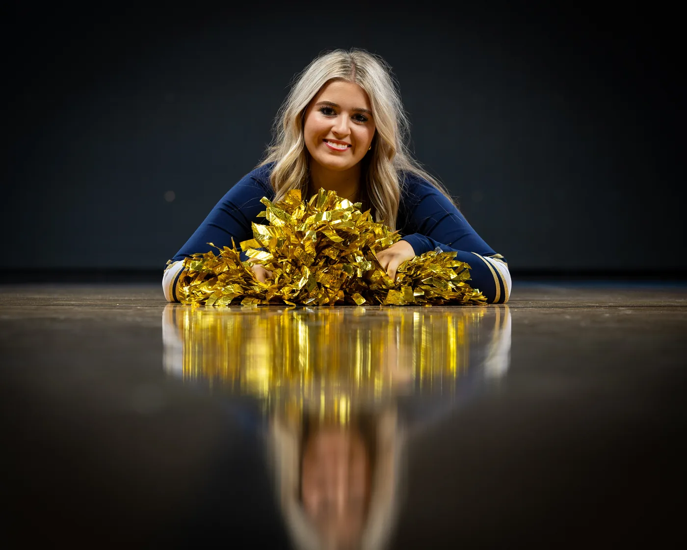 Middleton High School cheerleader portrait with gold poms on the court Middleton Idaho