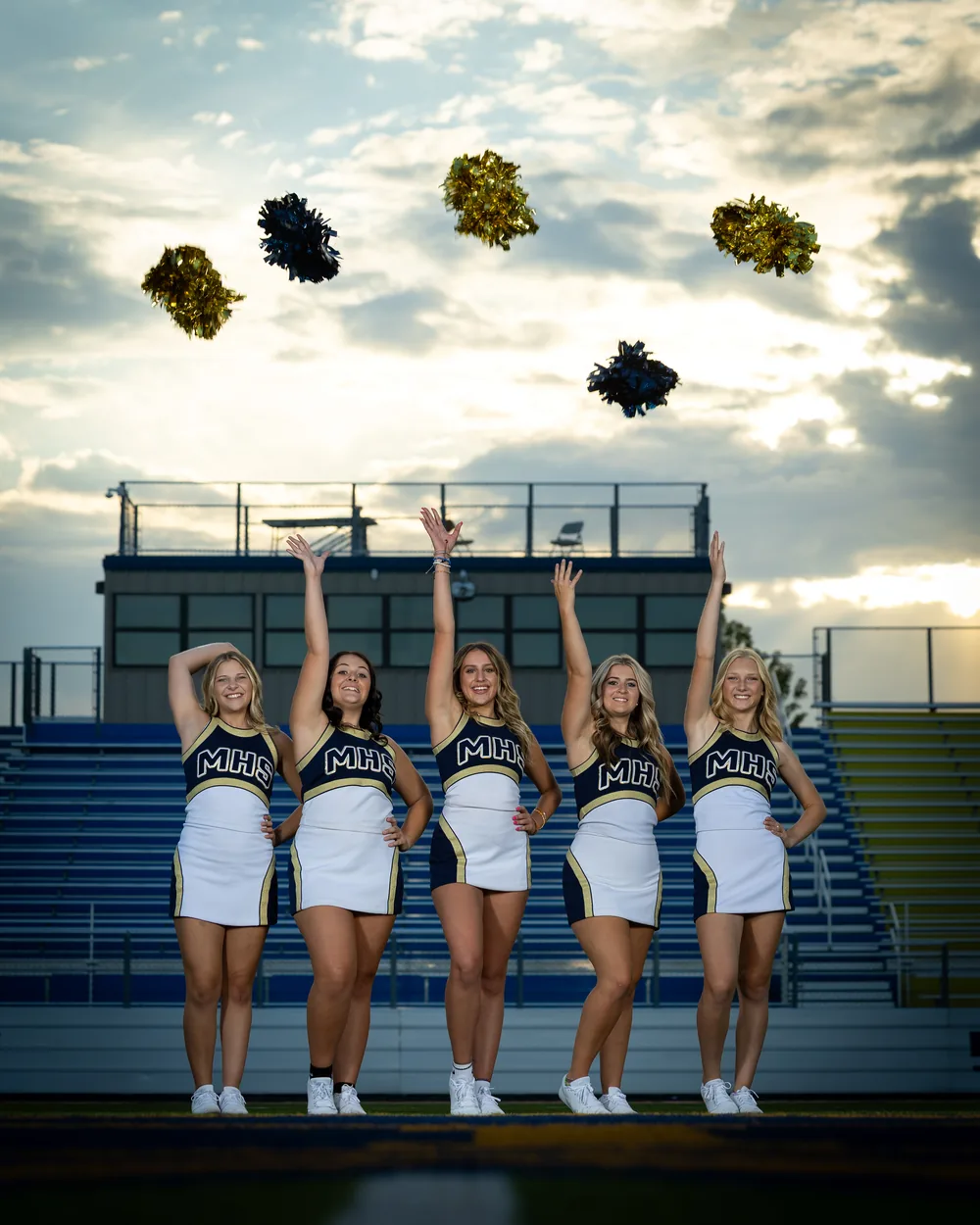 Middleton High School cheer squad throwing poms at sunset Middleton Idaho